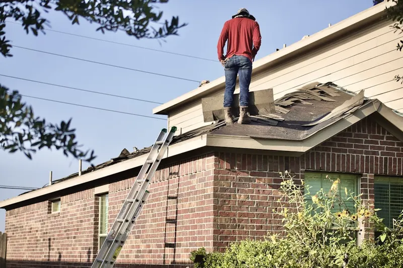 Professional roofer working on a residential roof in Baltimore